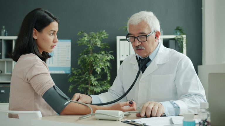 Primary care doctor talking with a patient in an exam room
